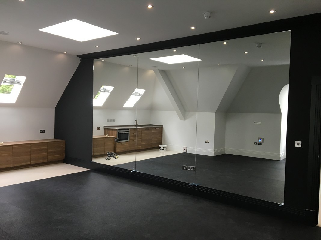 Frameless glass wall dividing loft conversion in Oxford